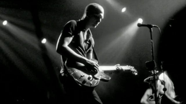 Video Reference: guitarist, bassist, string instrument, black, rock concert, string instrument accessory, musician, black and white, music artist, drummer