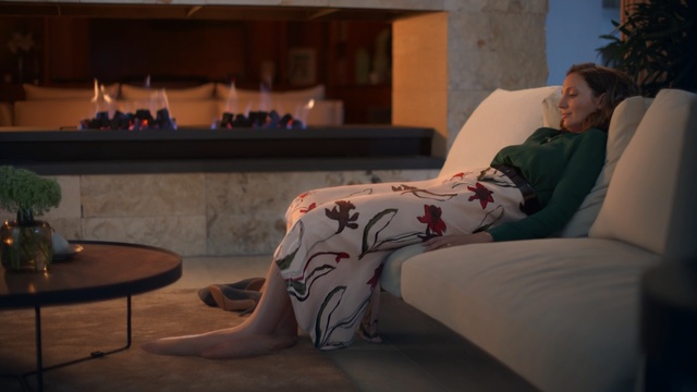 Video Reference: Room, Furniture, Couch, Leg, Sky, Tree, Sitting, Comfort, Interior design, House, Indoor, Person, Bed, Table, Laptop, Man, Woman, Living, Television, Computer, Using, Young, Large, White, Standing, Holding, Board, Laying, Bedroom, Tattoo