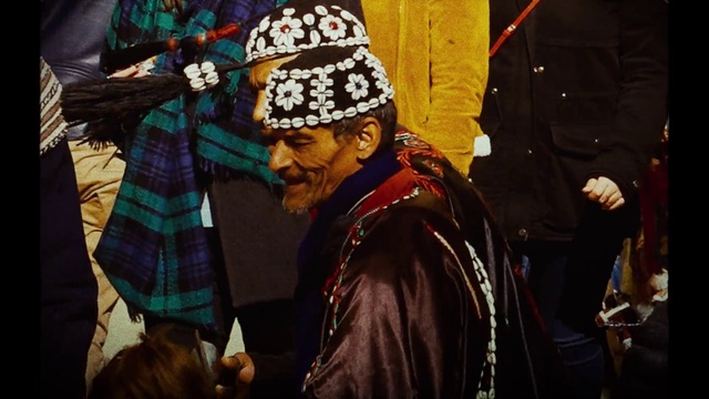 Video Reference: Outerwear, Street fashion, Headgear, Public space, Cap, Jacket, Tartan, Event, Crowd, Scarf