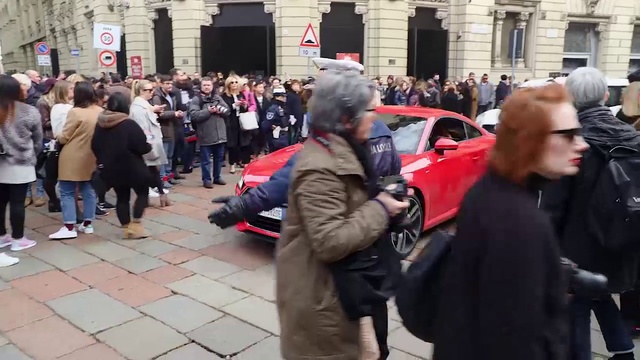 Video Reference: Hair, Fashion, Motor vehicle, Standing, Car, Building, Street fashion, Jacket, City, Event