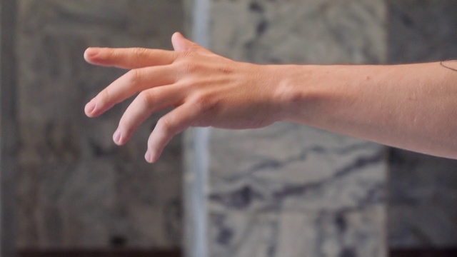 Video Reference: Finger, Hand, Nail, Gesture, Arm, Thumb, Wrist, Person, Building, Using, Holding, Woman, Sitting, White, Black, Food, Young, Man, Blue, Red, Playing, Remote, Pizza, Watch