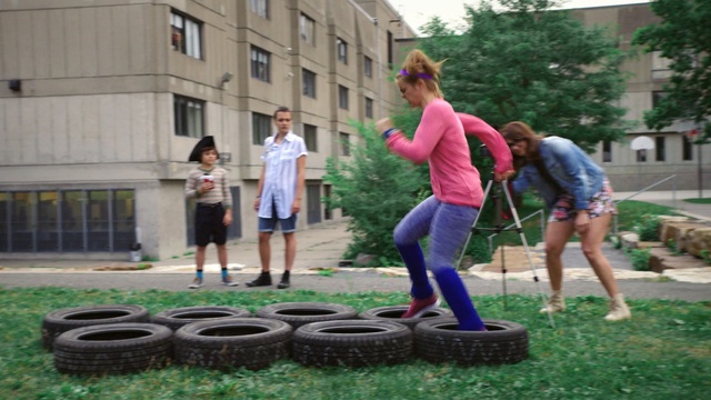 Video Reference: public space, playground, fun, recreation, outdoor play equipment, play, plant, tree, grass, city, Person