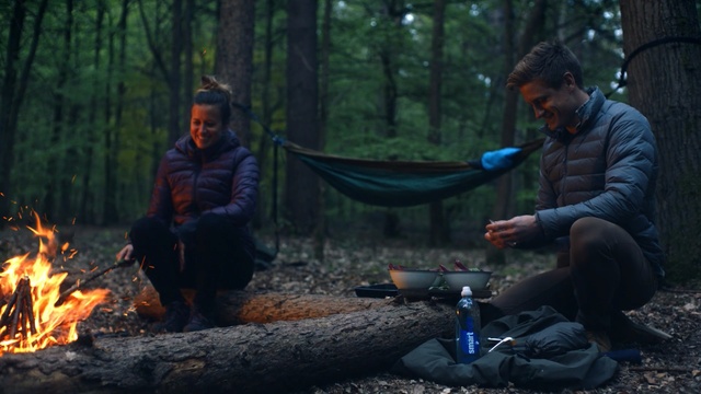 Video Reference: forest, wilderness, tree, campfire, woodland, plant, darkness, screenshot, jungle, camping, Person