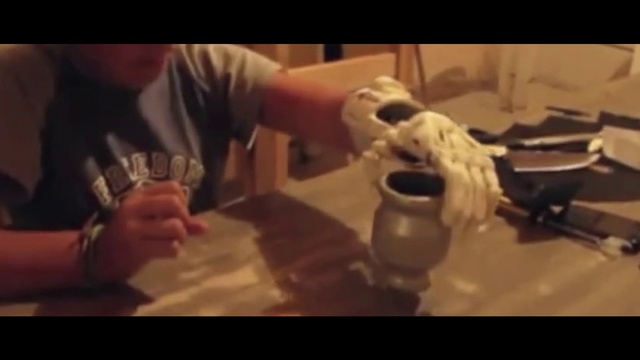 Video Reference: Arm, Hand, Alcohol, Mouth, Headgear, Music, Art, Photography, Personal protective equipment, Table