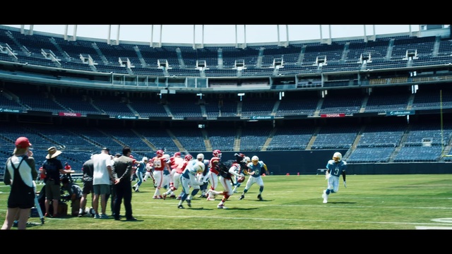 Video Reference: Sports, Sport venue, Stadium, Team sport, Player, Soccer-specific stadium, Team, Arena, Ball game, Atmosphere, Outdoor, Grass, Building, Game, Ball, Water, Standing, Baseball, Playing, Large, People, Field, Man, Group, Woman, Holding, Court, Green, Dog, Walking, Soccer, White, Crowd, Person, Sports equipment, Football, Sport, Tennis