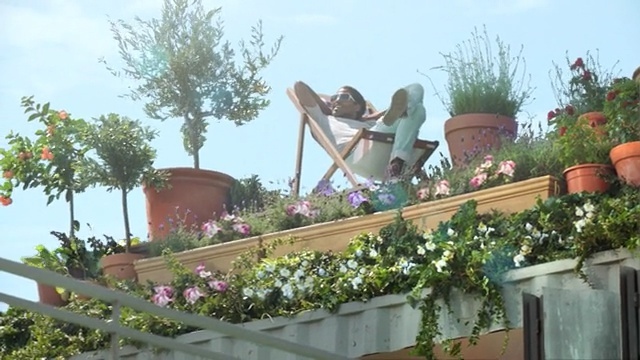 Video Reference: plant, flower, tree, flora, garden, outdoor structure, recreation, flowering plant, leisure, park, Person