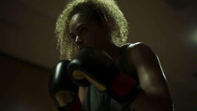 Video Reference: Microphone, Audio equipment, Arm, Boxing glove, Muscle, Photography, Technology, Singing, Electronic device, Singer, Person, Indoor, Wearing, Young, Sitting, Black, Looking, Man, Holding, Computer, Shirt, White, Table, Boy, Standing, Head, Desk, Room, Hat, Red, Stuffed, Human face