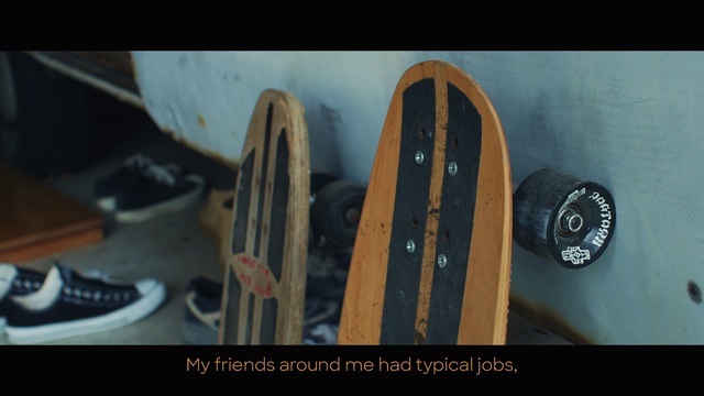 Video Reference: Skateboard, Longboard, Skateboarding equipment, Sports equipment, Rim, Wheel, Sitting, Shoes, Photo, Small, Wooden, View, Black, Different, Pair, Board, Table, Man, Blue, White, Text