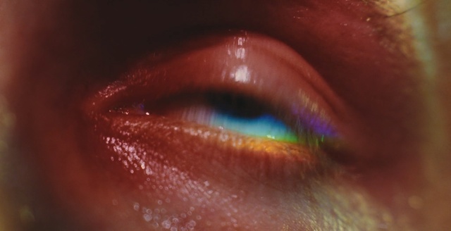 Video Reference: Eye, Close-up, Iris, Blue, Eyebrow, Skin, Organ, Eyelash, Lip, Flesh, Thing, Sitting, Bowl, Close, Orange, Closeup, Blurry, Table, Glass, Red, White, Eyes, Cosmetics, Cosmetic, Mouth, Eye shadow