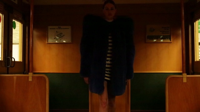 Video Reference: Standing, Shoulder, Room, Outerwear, Wood, Human body, Hardwood, Furniture, Dress, Interior design