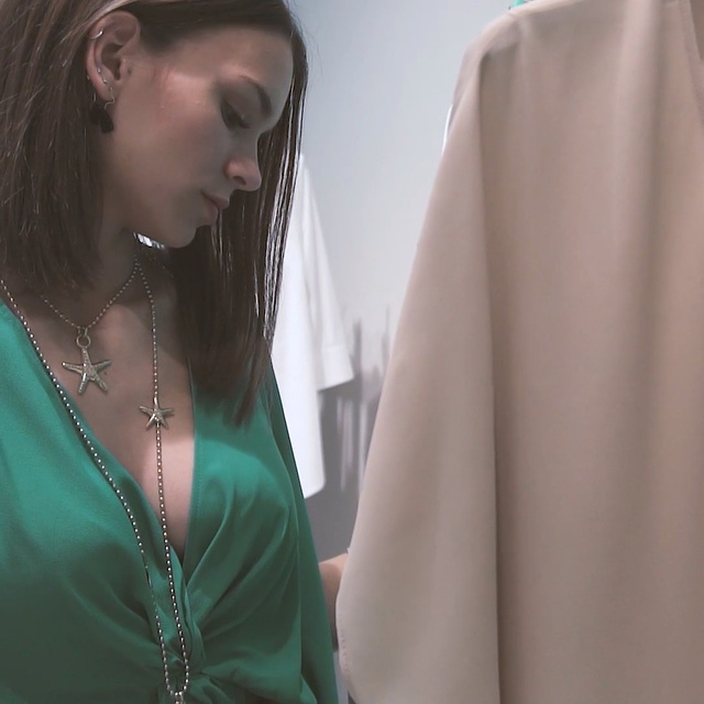 Video Reference: Green, Shoulder, Neck, Turquoise, Outerwear, Sleeve, Joint, Textile, Dress, Blouse, Person, Woman, Indoor, Clothing, Shirt, Looking, Holding, Lady, Standing, Wearing, Glasses, Man, Girl, Young, Hair, Smiling, Table, Phone, White, Knife, Cake, Wedding, Red, Train, Room, People, Fashion accessory, Human face, Necklace, Wedding dress, Bride