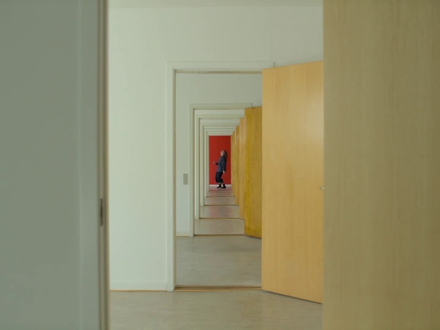 Video Reference: Room, Yellow, Wall, Floor, House, Line, Building, Interior design, Material property, Plaster