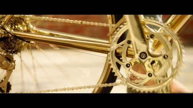 Video Reference: spoke, bicycle wheel, bicycle, rim, road bicycle, wheel, bicycle frame, bicycle part, brass instrument, bicycle chain, Person