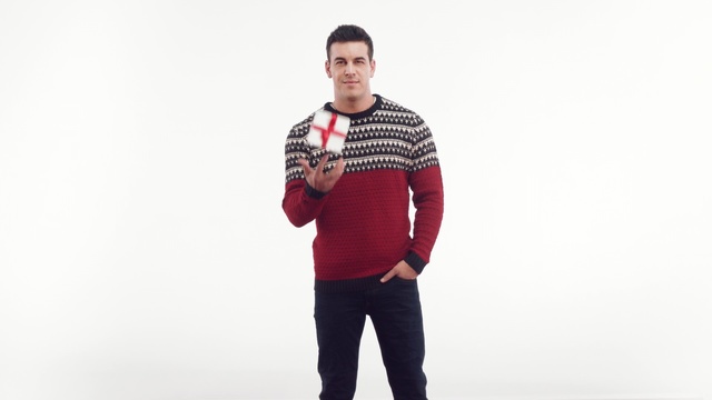 Video Reference: shoulder, sleeve, t shirt, standing, sweater, outerwear, neck, gentleman, pattern, joint, Person