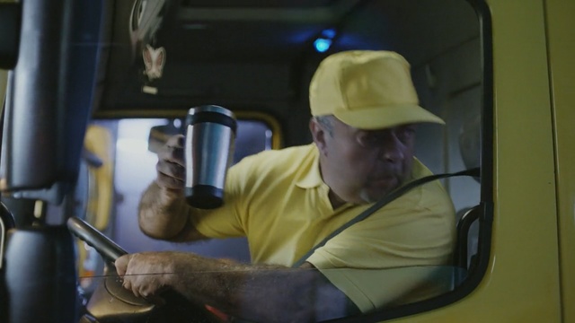 Video Reference: truck, cup, cap, yellow, driver, driving, employee