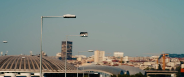 Video Reference: Street light, Skyline, City, Lighting, Light fixture, Sky, Urban area, Metropolitan area, Architecture, Downtown, Person