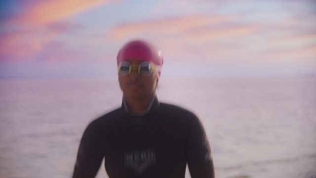 Video Reference: Wetsuit, Swim cap, Sky, Headgear, Endurance sports, Recreation, Sea, Personal protective equipment, Cap, Triathlon