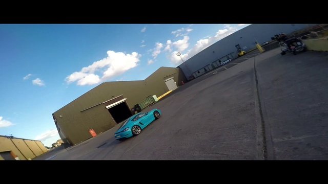 Video Reference: Mode of transport, Asphalt, Transport, Vehicle, Automotive exterior, Architecture, Rear-view mirror, Sky, Race track, Screenshot