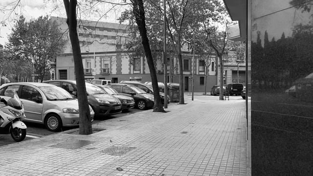 Video Reference: Street, Urban area, Black-and-white, Vehicle, Town, Neighbourhood, Car, Sidewalk, Snapshot, Road