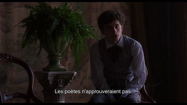 Video Reference: Photograph, Facial expression, Darkness, Male, Human, Sitting, Lady, Screenshot, Tree, Smile, Person, Man, Indoor, Table, Front, Window, Laptop, Holding, Computer, Black, Dark, Glasses, Standing, Young, Wearing, Shirt, Lit, Vase, Suit, Desk, Woman, Cake, Room, White, Human face, Clothing