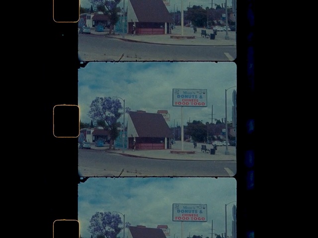 Video Reference: Sky, Blue, Text, Line, Architecture, Urban area, Square, Urban design, Photography, City, Traffic, Sign, Outdoor, Street, Light, Background, Stop, Sitting, View, Dark, Red, Orange, Hanging, Highway, Busy, White, Driving, Signal, Bus, Road, Screenshot, Billboard