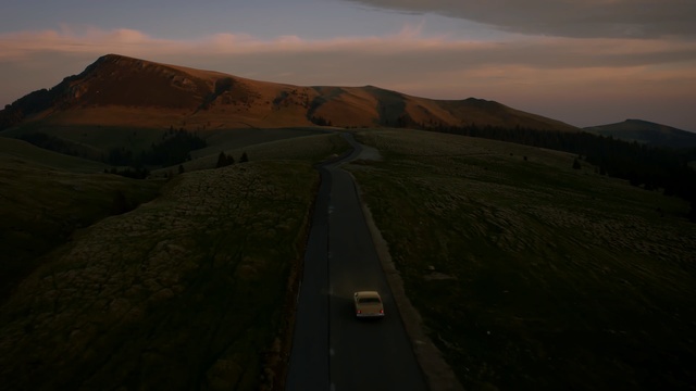 Video Reference: Highland, Sky, Mountainous landforms, Hill, Horizon, Road, Ecoregion, Terrain, Morning, Fell