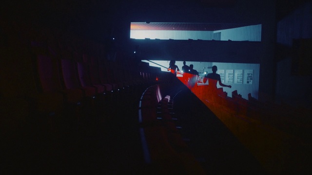 Video Reference: Red, Light, Night, Sky, Architecture, Darkness, Line, Room, Photography, Midnight, Person, Indoor, Dark, Computer, Television, Monitor, Screen, Laptop, Sitting, Lit, Front, Man, Desk, Lamp, Table, Bed, Keyboard, Black, Large, Cat, Standing, Living, Blurry, Image