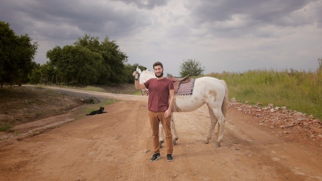 Video Reference: Horse, Working animal, Pack animal, Mane, Ecoregion, Rural area, Adaptation, Dirt road, Photography, Mare, Person