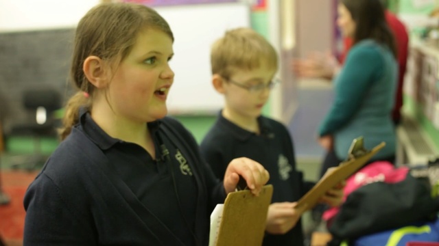 Video Reference: room, child, community, private school, education, girl, school, fun, student, learning, Person