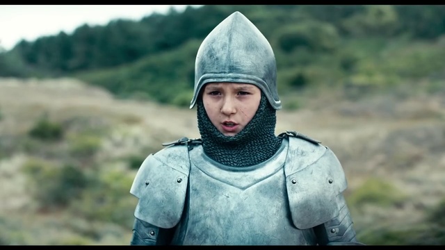 Video Reference: Helmet, Armour, Knight, Personal protective equipment, Headgear, Screenshot, Middle ages, Smile, Outdoor, Person, Clothing, Grass, Man, Wearing, Uniform, Holding, Field, Standing, Mountain, Hat, Small, Young, Boy, Carrying, Military, Green, Little, Riding, Walking, White, Woman, Board, Large, Red, Horse, Blue, Street, Bear, Kite, Human face, Jacket, Armor