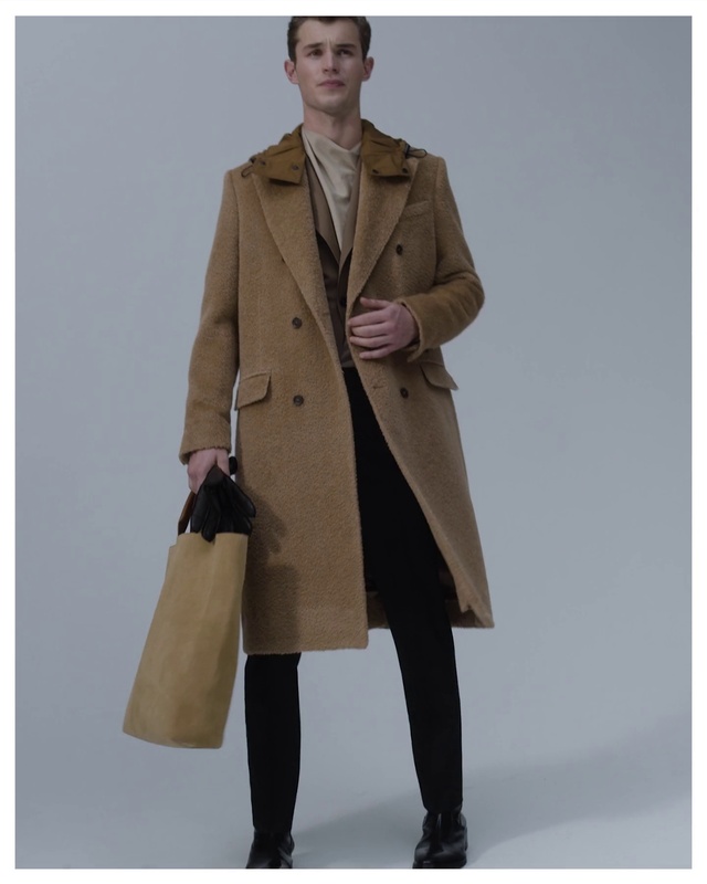 Video Reference: Clothing, Footwear, Outerwear, Overcoat, Frock coat, Sleeve, Beige, Collar, Street fashion, Jacket