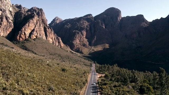 Video Reference: Sky, Mountain, Plant, Natural landscape, Bedrock, Terrain, Road, Landscape, Travel, Tree