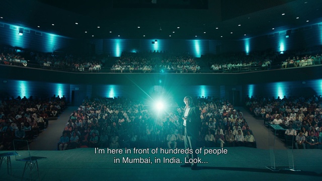 Video Reference: Entertainment, Concert, Performing arts, Chair, Flat panel display, Technology, Music venue, Stage, Display device, Crowd