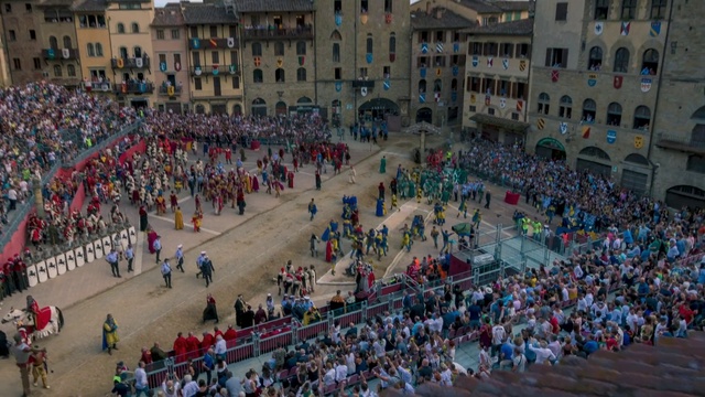 Video Reference: Crowd, People, Public space, Human settlement, Town square, City, Sport venue, Architecture, Plaza, Audience