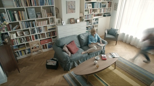 Video Reference: Living room, Furniture, Room, Floor, Property, Interior design, Wood flooring, Couch, Shelving, Laminate flooring, Person