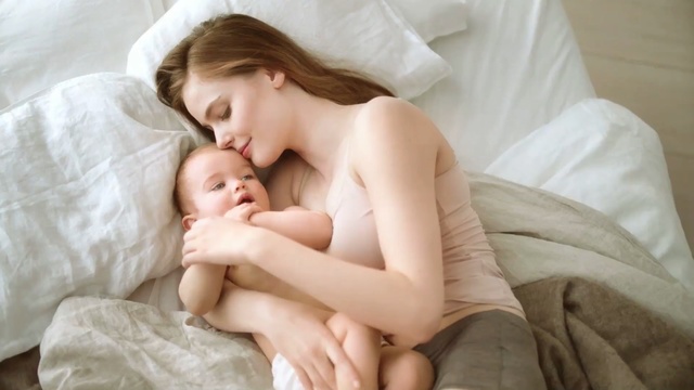 Video Reference: parent, child, mother, bed, baby, love, dad, lying, father