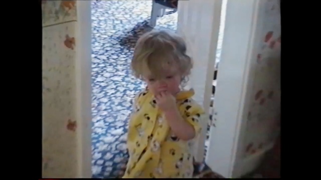 Video Reference: hair, clothing, face, child, skin, human hair color, toddler, yellow, facial expression, dress, Person
