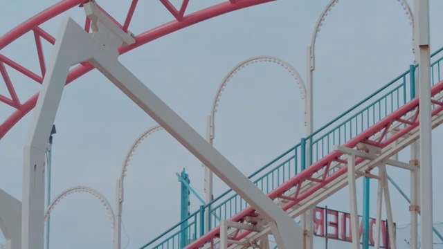Video Reference: amusement ride, roller coaster, amusement park, structure, tourist attraction, recreation, park, fixed link, leisure, Person