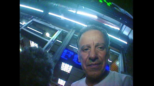 Video Reference: Photography, Fun, Technology, Display device, Selfie, Electronic device, Space, Person, Man, Indoor, Monitor, Front, Screen, Television, Looking, Standing, Holding, Window, Smiling, Shirt, Black, Wearing, Large, Room, Video, Computer, Display, Bus, Blue, Game, Human face, Clothing, Smile