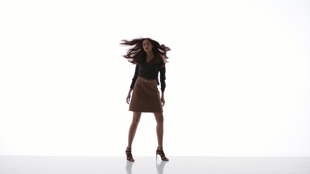 Video Reference: Fashion model, Clothing, Shoulder, Dress, Standing, Fashion, Brown, Joint, Outerwear, Neck