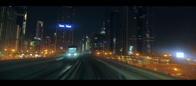 Video Reference: Metropolitan area, Cityscape, Metropolis, City, Urban area, Night, Skyscraper, Skyline, Downtown, Landmark, Outdoor, Building, Road, Street, View, Car, Traffic, Side, Stop, Highway, Busy, Many, Sign, Large, Water, Tall, Bus, Light, Sky, Way, Tower