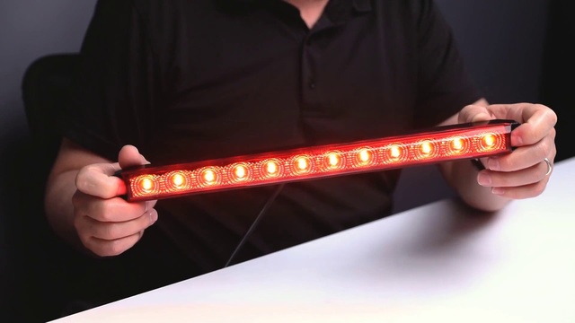 Video Reference: Light, Lighting, Person, Holding, Indoor, Man, Red, Hand, Remote, Front, Black, Food, Wearing, Screen, Shirt, Control, Large, Table, Head, Hat, Standing, Pizza, Video, Room, Text