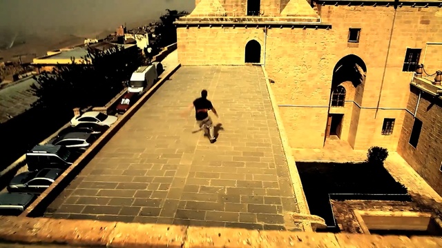 Video Reference: Wall, Shadow, Yellow, Sky, Architecture, Building, Tints and shades, World, Square, Person