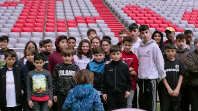 Video Reference: Shirt, Organ, Social group, T-shirt, Red, Leisure, Crowd, Fan, People, Smile