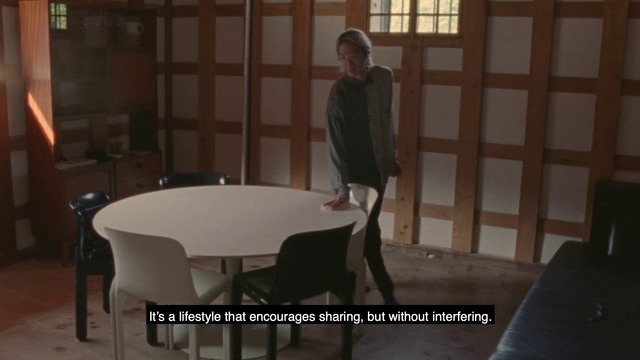 Video Reference: Furniture, Table, Chair, Room, Property, Floor, Hardwood, Interior design, Screenshot, Flooring, Person, Indoor, Sitting, Window, Building, Front, Standing, Black, Living, Man, White, Large, Bed, Computer, Woman, Door, Young, Bedroom, Umbrella, Kitchen, Clothing, Dining table