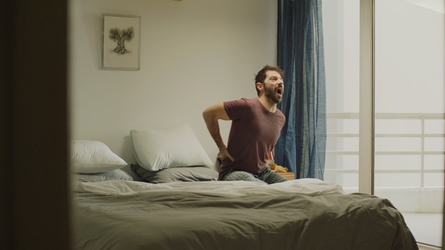Video Reference: Bed, Bedroom, Room, Bed sheet, Mattress, Furniture, Comfort, Leg, Muscle, Sitting, Indoor, Window, Woman, White, Laying, Standing, Young, Large, Man, Wall, Couch, Pillow, Curtain, Sofa bed, Person, Bedding