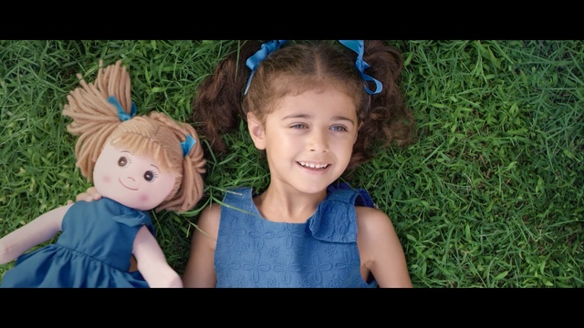 Video Reference: blue, child, people, face, green, facial expression, skin, human hair color, grass, smile, Person