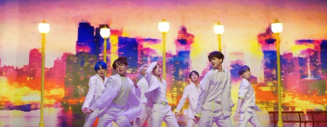 Video Reference: Purple, Fun, Yellow, Youth, Event, Performance, Magenta, Person, Indoor, Man, Standing, Wearing, Playing, Young, Dressed, Group, Woman, Game, Table, Room, Player, Colorful, Girl, Holding, Field, Soccer, Kitchen, Living, Wii, People, Dance, Painting, Clothing, Colored