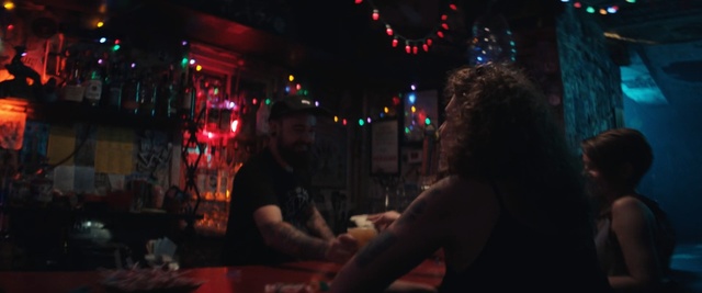 Video Reference: Darkness, Fun, Room, Nightclub, Bar, Photography, Night, Pub, Midnight, Person, Man, Sitting, Looking, Table, Woman, Front, Light, Standing, Holding, Young, People, Game, Playing, Street, Phone, Restaurant, Food, City, Video, Pizza, Human face, Clothing, Crowd