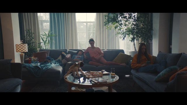 Video Reference: Living room, Couch, Photograph, Room, Furniture, Interior design, Property, Table, House, Home, Indoor, Living, Window, Coffee, Looking, Sitting, Filled, Television, Glass, Blue, Dog, Orange, Red, Bedroom, Large, Sun, Woman, Fire, White, Man, Person, Clothing, Chair, Coffee table